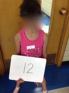 I took pictures of my kids with their iPad numbers and then set those photos to be their iPad screensavers!  This way, we knew which iPad belonged to which student.