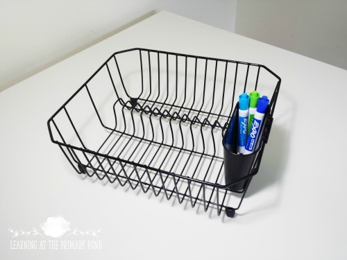 I use this dish rack for storing dry erase boards, markers, and erasers (I use baby socks as erasers!)